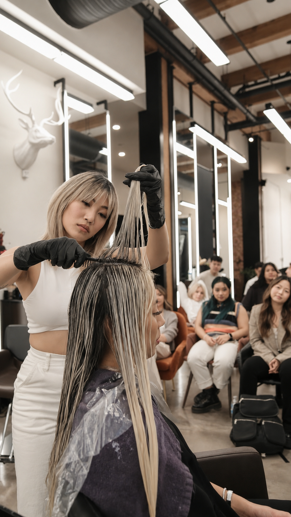 Close-up of weaving and placement on a model during a live Impact Blonding class.